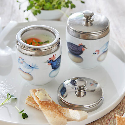 Coquetiers en porcelaine avec motifs coq et poule, &oelig;uf &agrave; la coque servi sur un plateau, ambiance printani&egrave;re