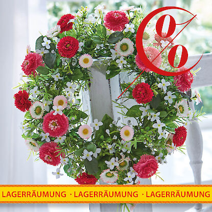 Rabattierter Blumenkranz mit roten und wei&szlig;en Bl&uuml;ten als fr&uuml;hlingshafte Fensterdekoration zur Lagerr&auml;umung