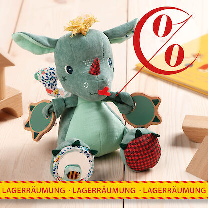 Rabattiertes Stoff-Drachenspielzeug mit Holzbausteinen und Kinderbuch bei Lagerr&auml;umung