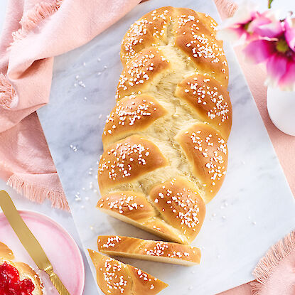 Frisch gebackener Hefezopf mit Zuckerperlen, serviert mit Marmelade